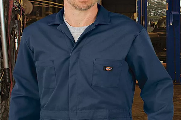 A picture of a man wearing a mechanic's overalls