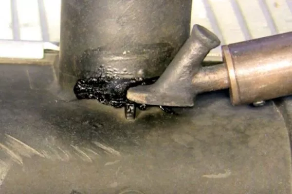 A picture of a radiator hose with a hole caused by high temperature