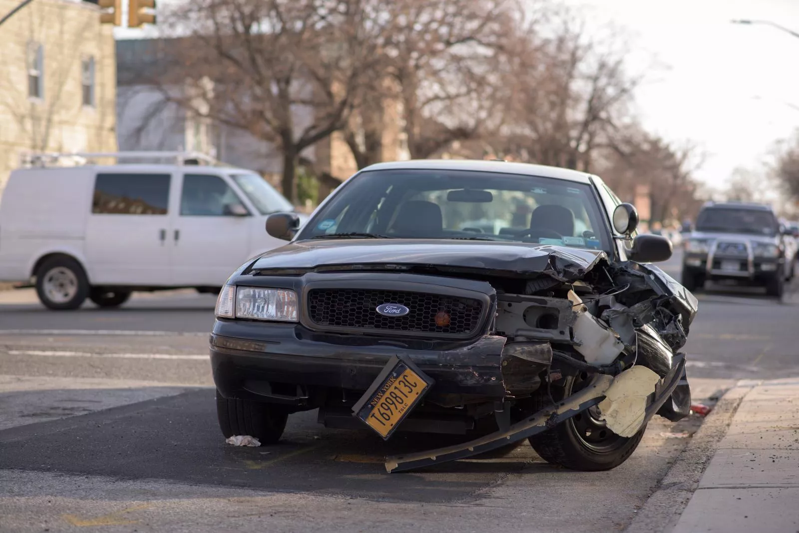 A wrecked black Ford