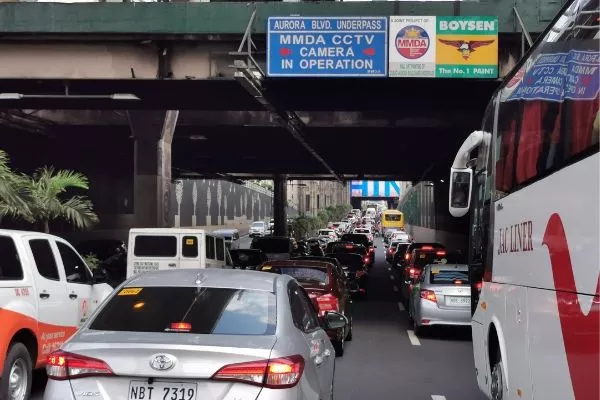 A picture of an overpass in EDSA with a no contact apprehension sign.