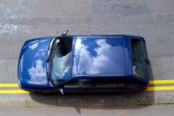 If you needed to stop your car on the side of the highway, ensure that there’s enough space between you and the road. a parked blue car