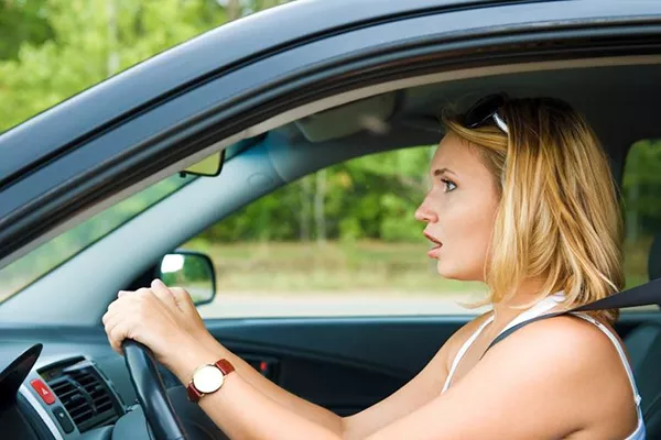 A picture of a nervous lady driver