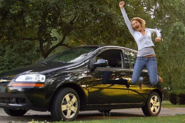 Woman jumping excitedly for her new car