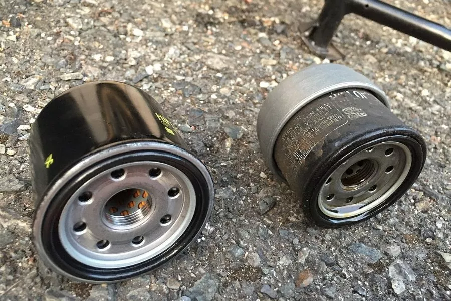 A picture of a new and old oil filter side by side.