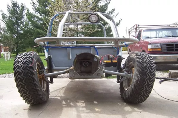 A picture of an off-road vehicle being assembled with positive camber