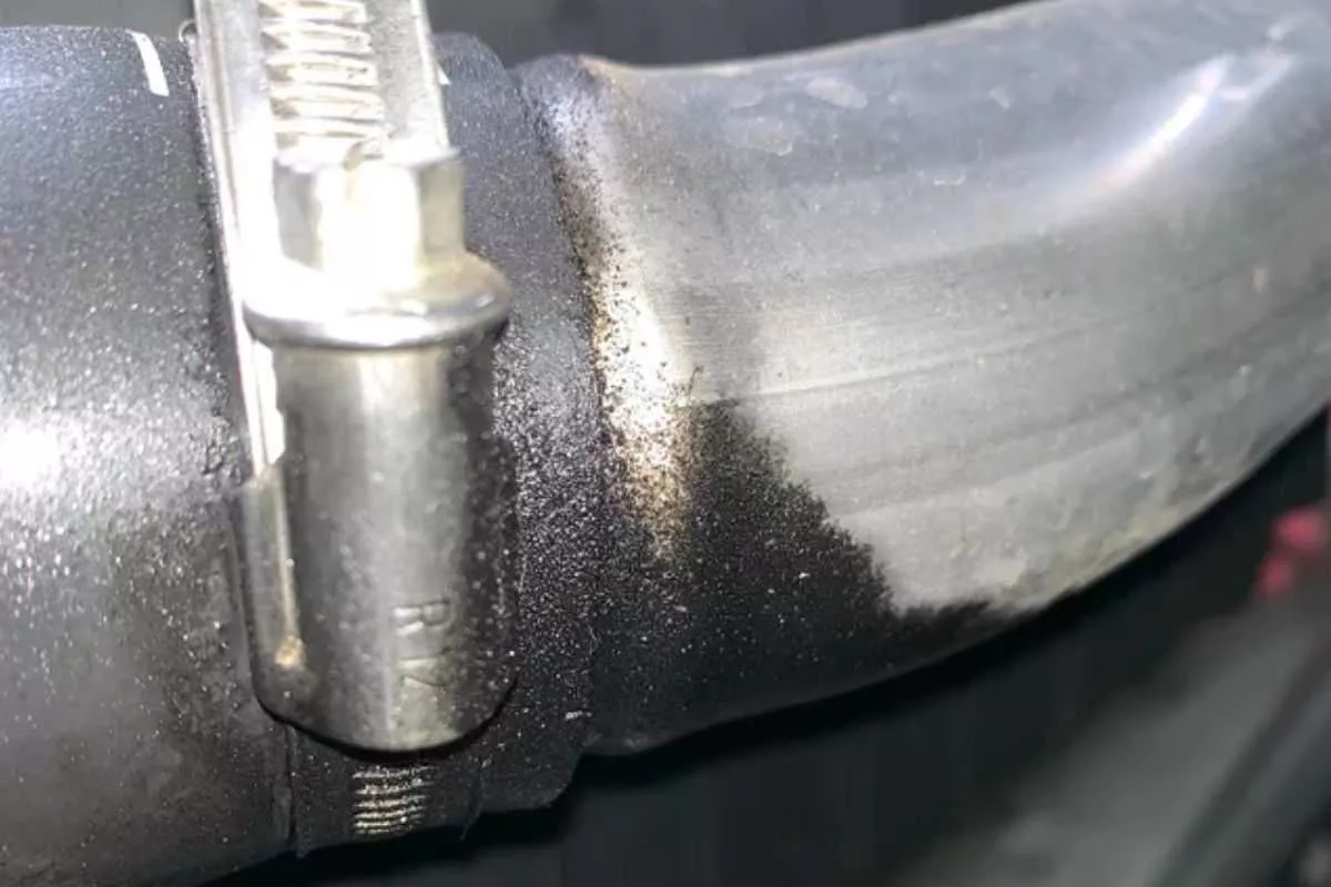 A picture of a leaky, oily intercooler hose