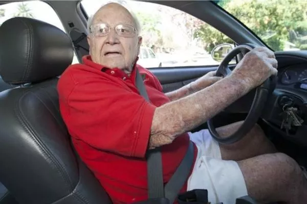 A picture of an old man about to drive