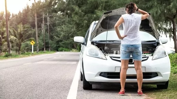 A woman checking her car engine