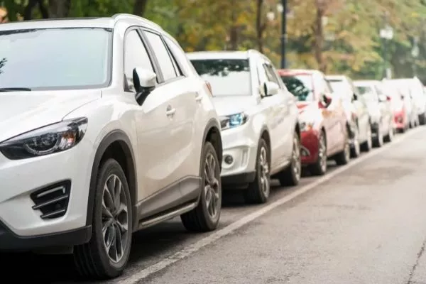A picture of cars parallel parked.