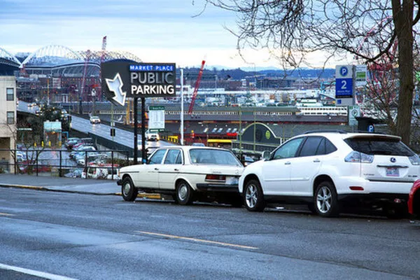 Two cars park in public parking