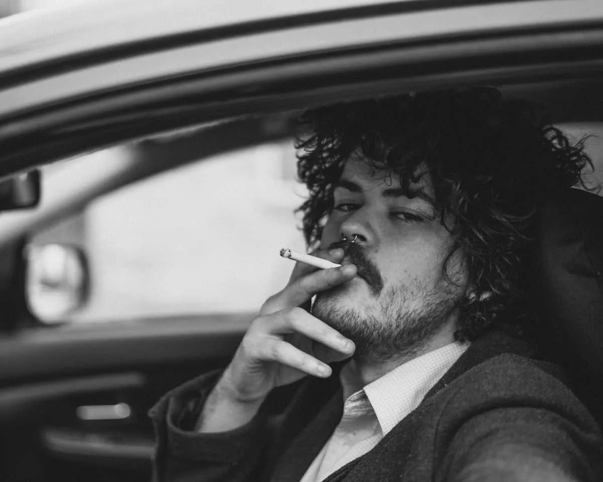 Man smoking in car