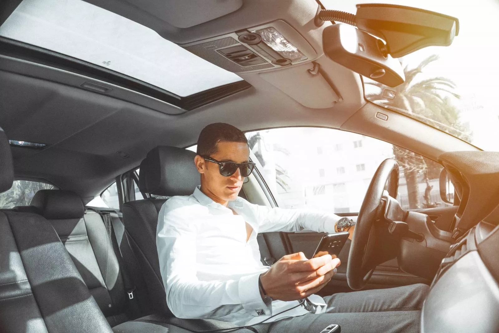 Man using phone while driving