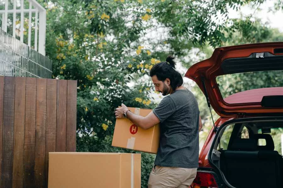 Man taking out boxes from car