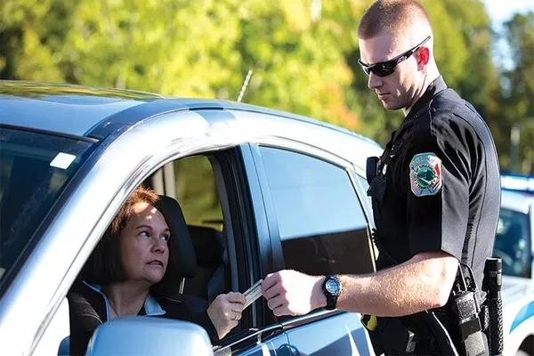 an officer confiscating a driver's license