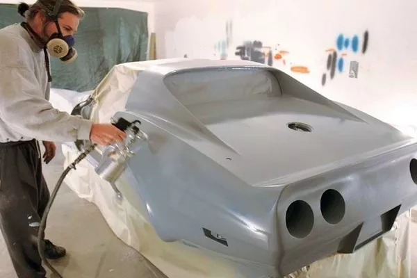 Man applying primer in car