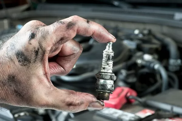 Man holding a sparkplug