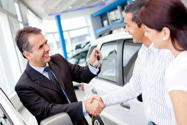 salesperson shaking hands with the couple