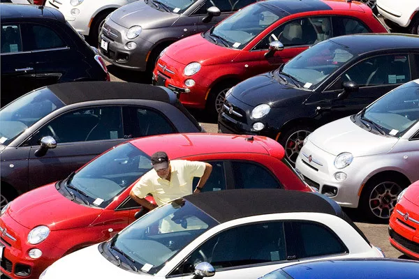 man is looking for a car