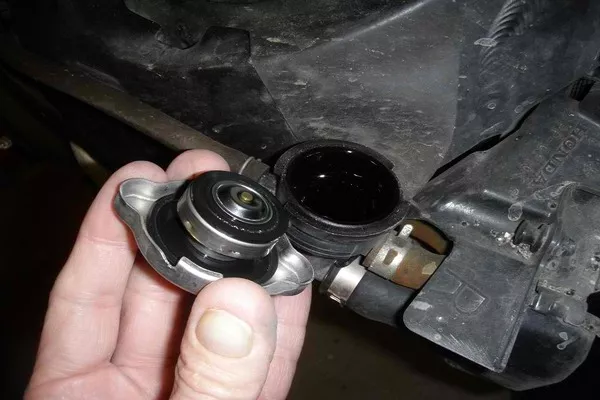 Man removing the radiator cap
