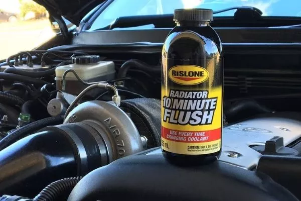 A picture of coolant flush on top of an engine