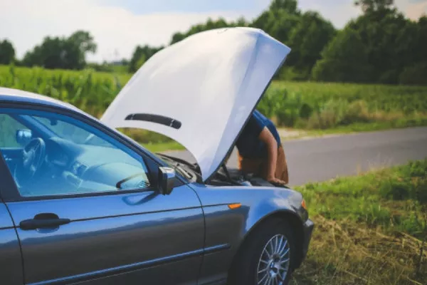 Man checking the engine of the car