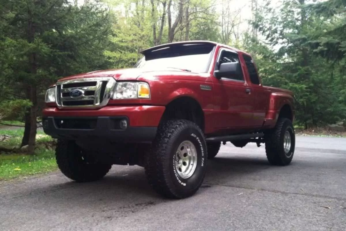 A photo of a Ford Ranger equipped with a body lift kit parked on a driveway