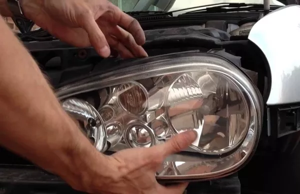 Man holding the car headlight