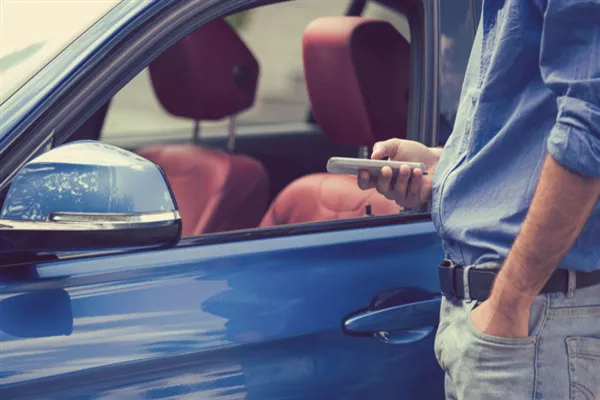 Man standing beside a car 