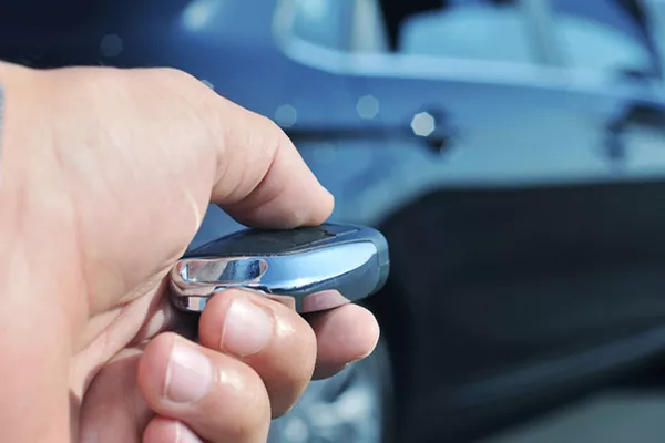 Man holding a car remote starter