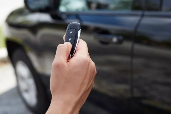 Man holding a car remote starter