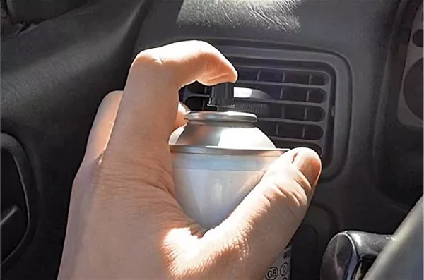 Man spraying the air-con of the car