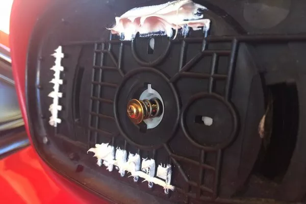 Now start scraping at the old glue using your razor-sharp scraper side mirror base with glue