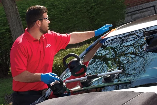 man replacing windshield