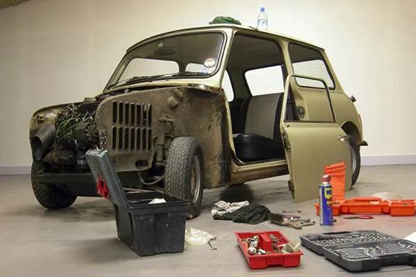 A picture of a car amidst a restoration job