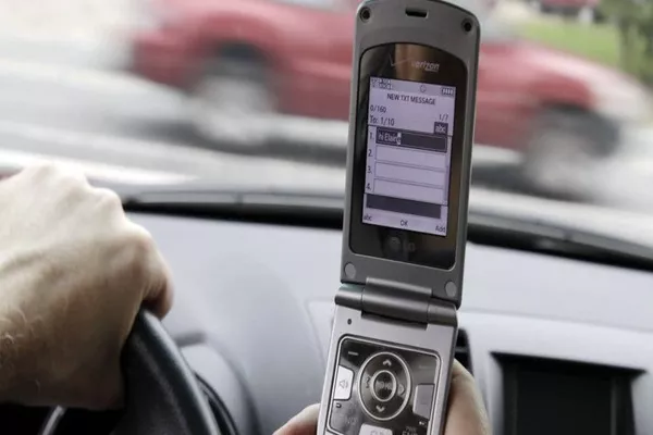 Man using phone while driving