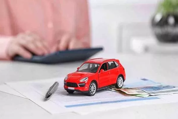 Not worrying about monthly payments is a plus from saving when you pay annually for your car insurance. cash stash and car toy on top of documents