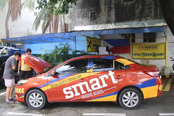 A picture of a student with his instructor at Smart Driving School