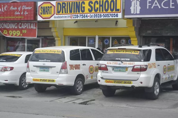 The Smart Driving School Parañaque branch showing their varied vehicle choices A picture of one of the branches of Smart Driving School and their vehicles