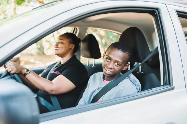 A lady and a youngster in the car