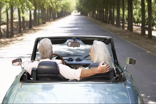 elder driving a car