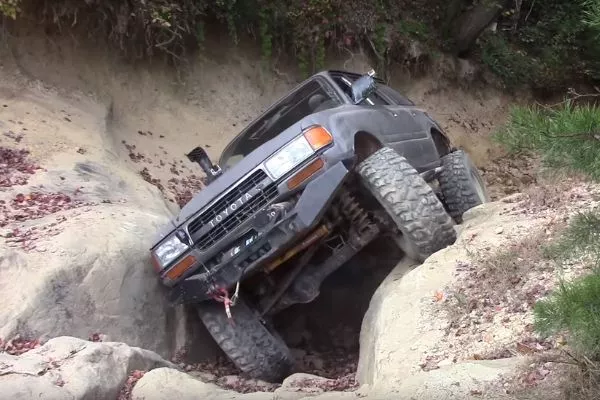 A picture of a Series 80 Toyota Land Cruiser off-roading.