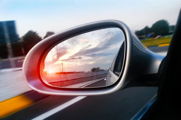 Utilize your side and rear-view mirrors for added safety a car side mirror
