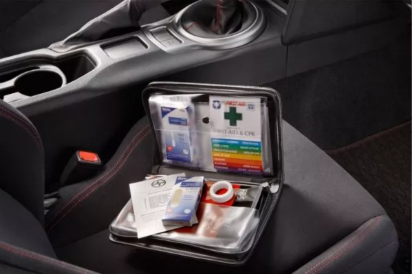 If you know CPR, you should also include a CPR face mask A picture of a small first aid kit inside a car
