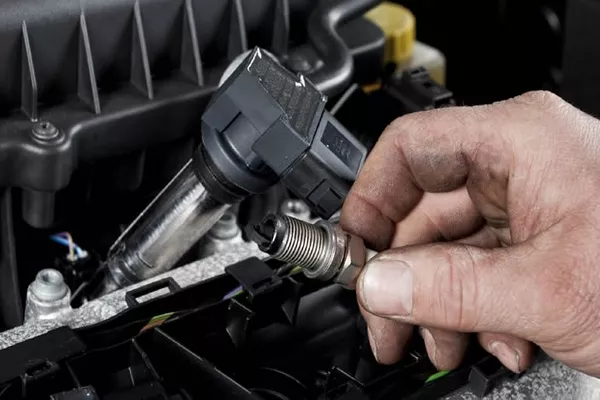 Man holding a spark plug