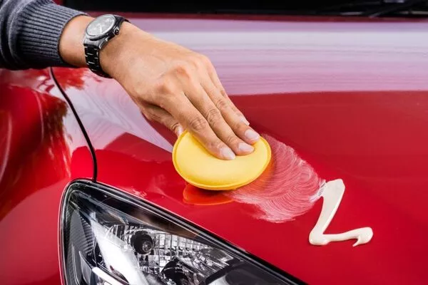 applying wax at the car exterior