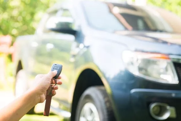 Man holding a car remote starter