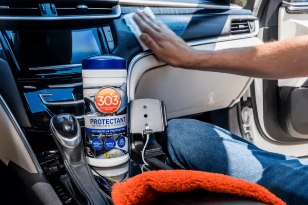 Man applying protectant to the plastic area