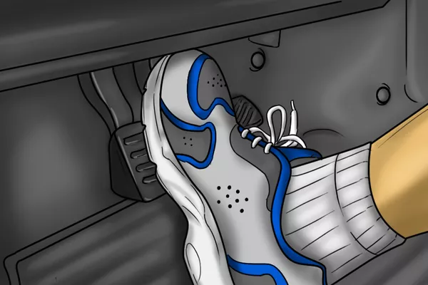 If you got the vehicle to slow down, then press on the brakes harder until it’s slow enough to maneuver off the road toes pressing the brakes illustration