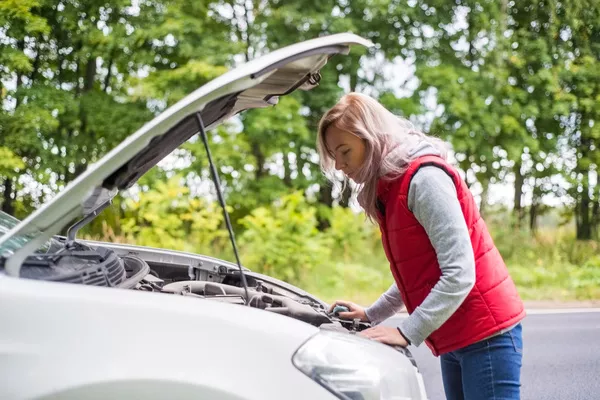 woman checking the engine