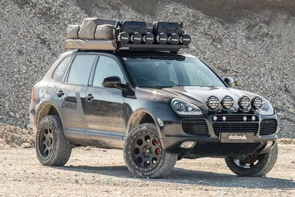 A picture of a Porsche Cayenne with a suspension lift kit in the desert